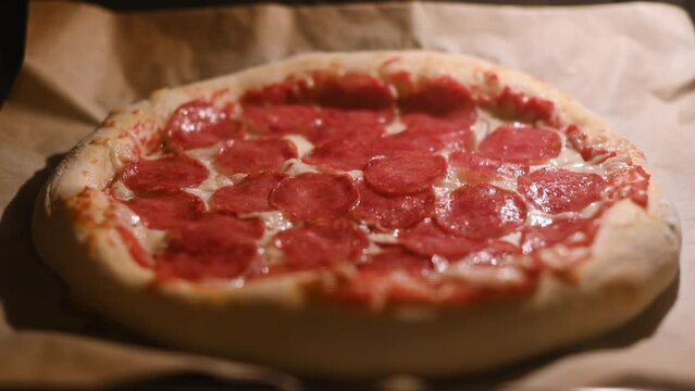 Time lapse video of baking pizza with salami pepperoni in a home electric oven. Pizza with salami in hot oven close up. Time lapse. UHD 4k video