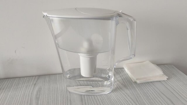 Filter jug with water on the table
