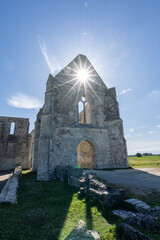 The ruin of the Xl century abbey des chateliers on the island of ile de re,france. sunlight streams...