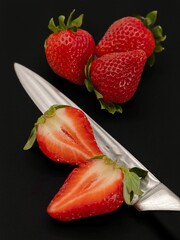 strawberries on a plate, black background 