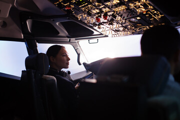 A female pilot controls a large passenger plane