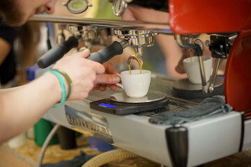 Barista making fresh aromatic coffee espresso, hands of bartender preparing coffee drink
