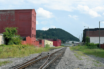 Fototapeta na wymiar Small American Town Railroad SIde Buildings and Track with Mountain in Background