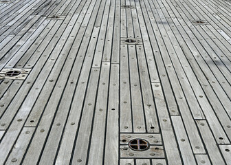 Macro View of Wooden Ship Decking and Embedded Metal Anchors and Fastenings