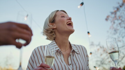 Carefree woman relaxing rooftop party closeup. Talking girl holding drink glass