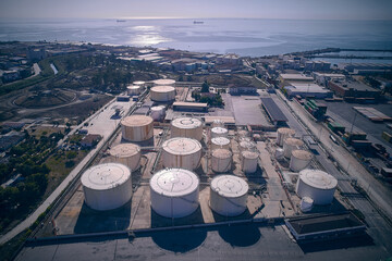 Aerial view of fuel tanks. Oil storage tanks aerial view. Oil and gas storage terminal. Petrochemical refinery plant