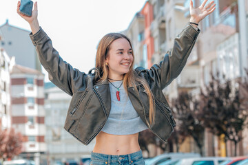 urban blonde girl on the street excited with joy - obrazy, fototapety, plakaty