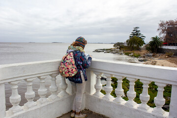 Latin woman travel. Colony, Uruguay. Old colonial city of cobblestone streets and stone houses. old...
