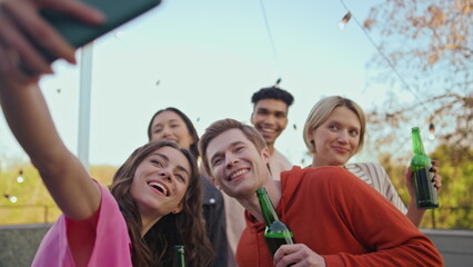 Cheerful friends making selfie at party closeup. Students partying at rooftop
