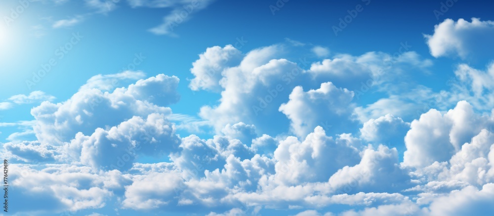 Poster view of the sky showing puffy clouds and a shining sun in a close-up shot, creating a serene and bea