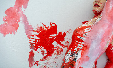 side view of upper body and breast of young sexy naked woman in shiny black, white and red paint color painted elegant on the Studio wall with colored bodyprints