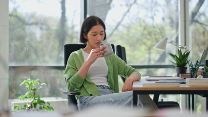 Lady enjoying tea cup break sitting office desk closeup. Business woman relaxing