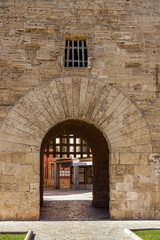 The 14th century  stone gate Porta del moll in Alcudia old town, Mallorca, Spain, Balearic Islands - obrazy, fototapety, plakaty