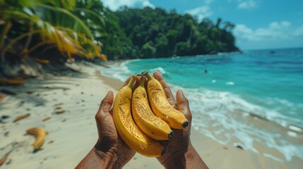 Man hands holding fresh bananas on the beach. Close-up