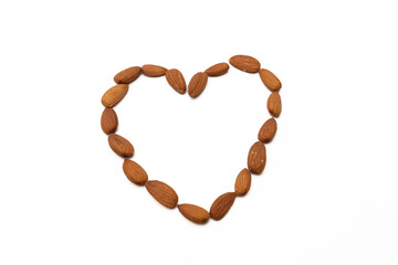 Almonds arranged in a heart shape, isolated on a white background, symbolizing healthy eating