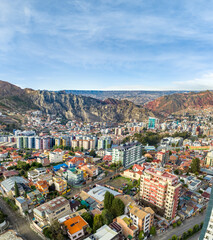 Naklejka premium La Paz, Bolivia, aerial view flying over the dense, urban cityscape. San Miguel, southern distric