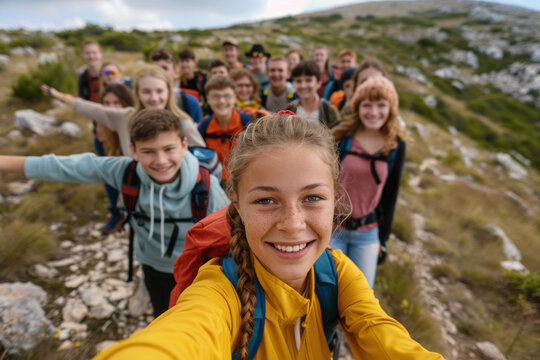 Active young kids, teenagers hiking in the mountains, summer camp