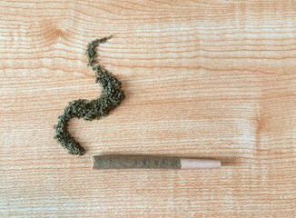Rolled marijuanna flower joint on top of a table, pre roll - obrazy, fototapety, plakaty