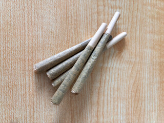 Rolled marijuanna flower joints on top of a table, pre rolls - obrazy, fototapety, plakaty