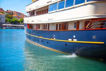 Side view of passenger ship moored on the harbor
