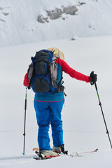 A Female Mountaineer Ascends the Alps with Backcountry Gear - 776492617