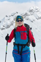 A Female Mountaineer Ascends the Alps with Backcountry Gear - 776496287