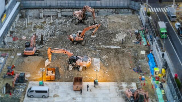Timelapse view of construction site showing several excavators and construction workers in central Nagoya, Japan.