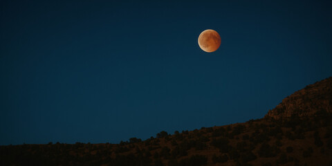 Red Super Moon in the night sky with copy space  - obrazy, fototapety, plakaty