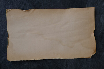 one horizontal textural sheet of paper, stack of sheets old retro paper without writing on black...
