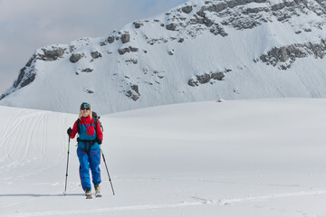A Female Mountaineer Ascends the Alps with Backcountry Gear - 776508628
