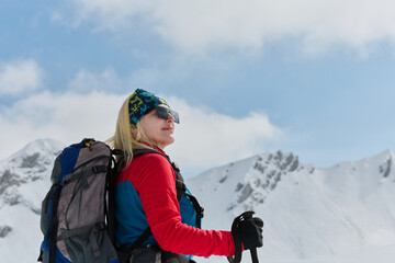 A Female Mountaineer Ascends the Alps with Backcountry Gear - 776512429