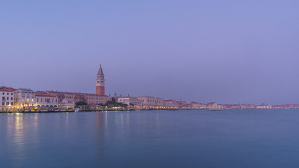 Panoramic view from sea of Piazza San Marco Campanile and Doge Palace during blue hour, Venice,...