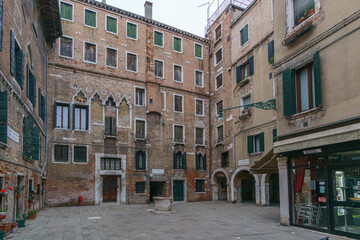Typical cityscape of small town square with surrounding buildings in Venice, Veneto, Italy
