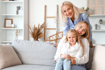 Cute little girl with her mother and granny at home
