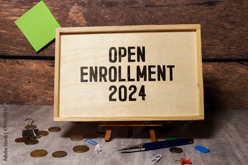 Poster concept of open enrollment 2024 write on sticky notes isolated on wooden table