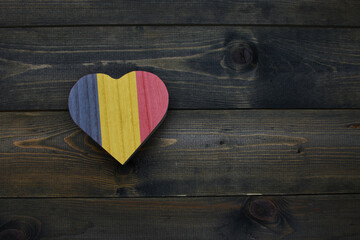 wooden heart with national flag of chad on the wooden background.