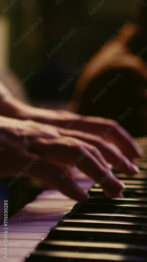 Fototapete Vertical Video Musician composer playing midi controller synthesizer in professional studio, composing music on mixing console. Artist performing on piano electronic keyboard in control room. Camera B