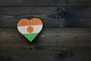 wooden heart with national flag of niger on the wooden background.