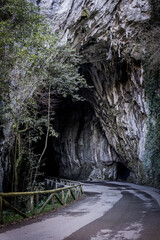 Roadway penetrates majestic cave, inviting travelers to explore Asturias' pristine landscapes.