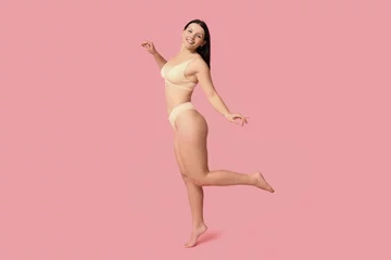 Gardinen Body positive young woman in underwear smiling on pink background © Pixel-Shot