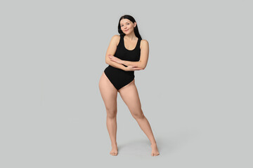 Body positive young woman on light background