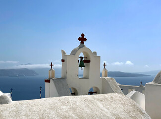 Bell tower in the town of Oia on the rocky shores of Santorini island