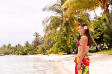 French Polynesia photo of woman wearing traditional pareo and Bikini relaxing on perfect beach on Bora Bora vacation travel. Completely unretouched, model has no makeup. Real people. Raw Image - 776555692