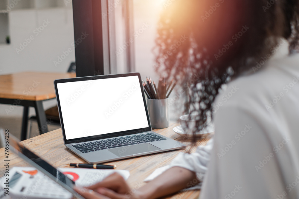 Poster close-up back view of a business woman working in the office typing, looking at the screen. office w
