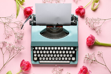 Vintage typewriter and flowers for Women's Day on pink background