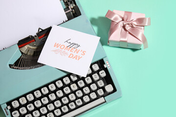 Vintage typewriter, gift box and postcard for Women's Day on turquoise background