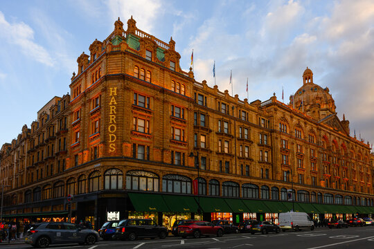 London, UK - March 22, 2024; Harrods department store in evening light as lights illuminate the historic facade