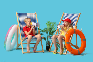 Little children lifeguards with ring buoy and megaphones sitting on deckchairs against blue...