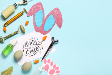 Composition with greeting card, cosmetologist's products and Easter decor on blue background