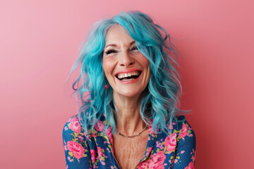 cute senior pretty woman with blue hair being happy on pink background